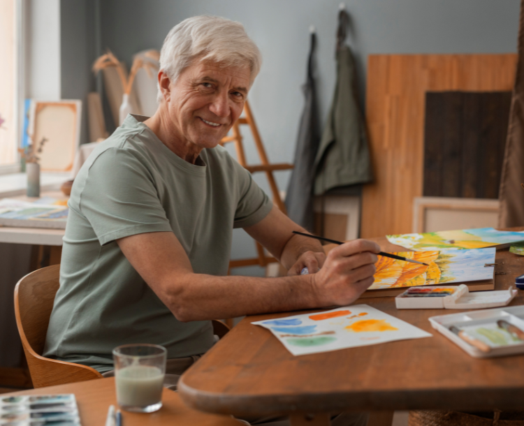 Active senior painting on canvas as part of rediscovering hobbies in retirement