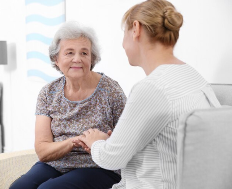 Senior woman talking to a mental health therapist at home